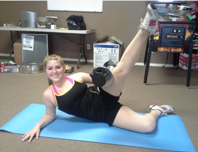 A client performing a side leg raise with an ankle weight